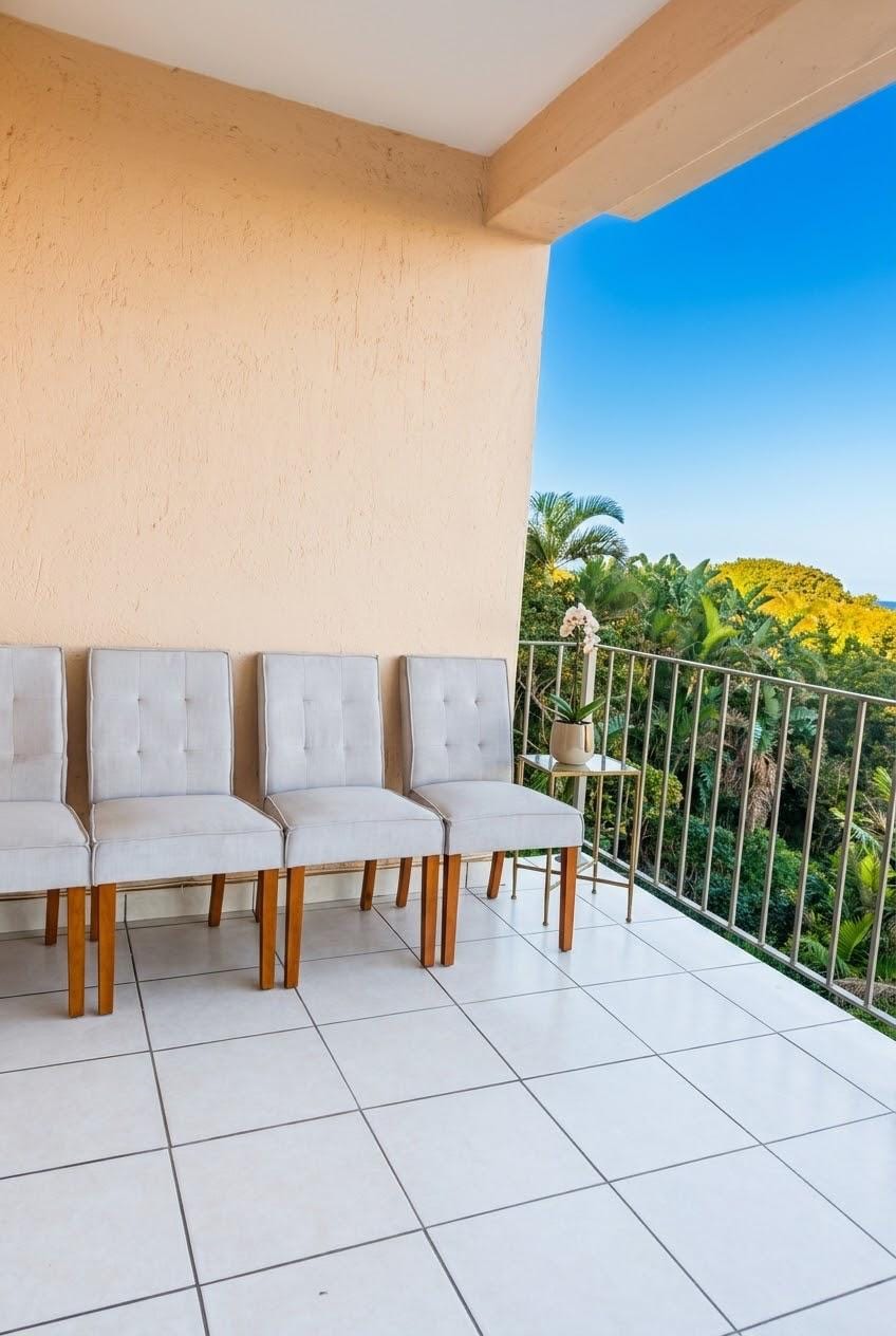 The covered balcony, with seating looking out over the treeline