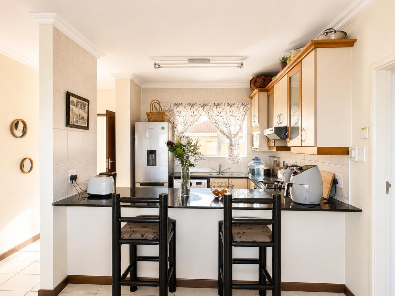The dining end: a granite breakfast counter with two bar stools