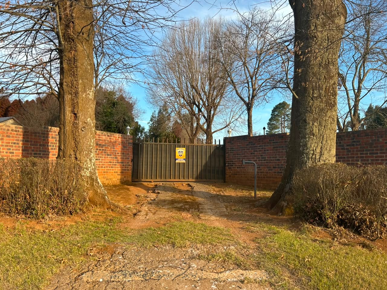 The entrance gate between two established trees
