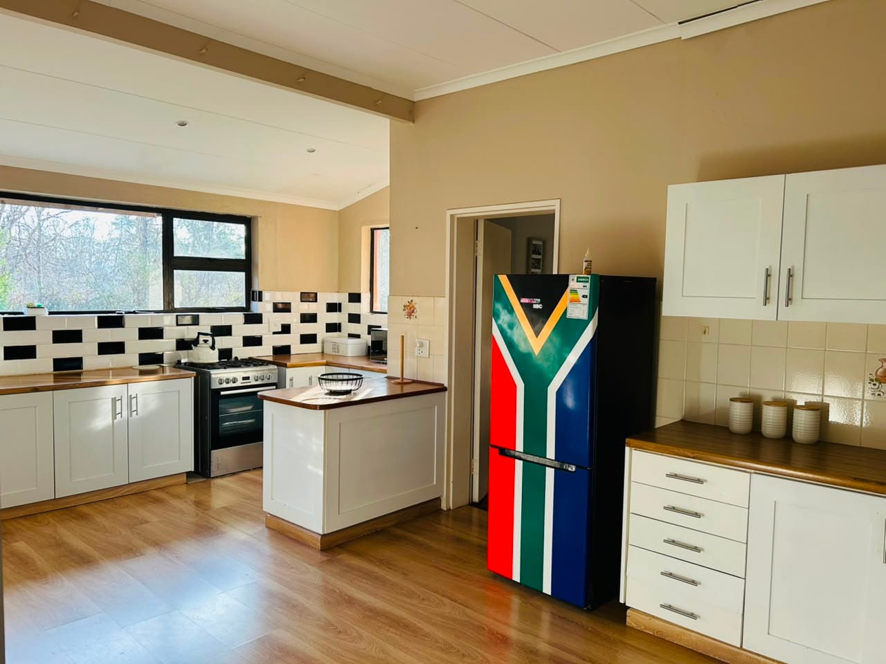 The kitchen from the far end, with the island and full-height fridge